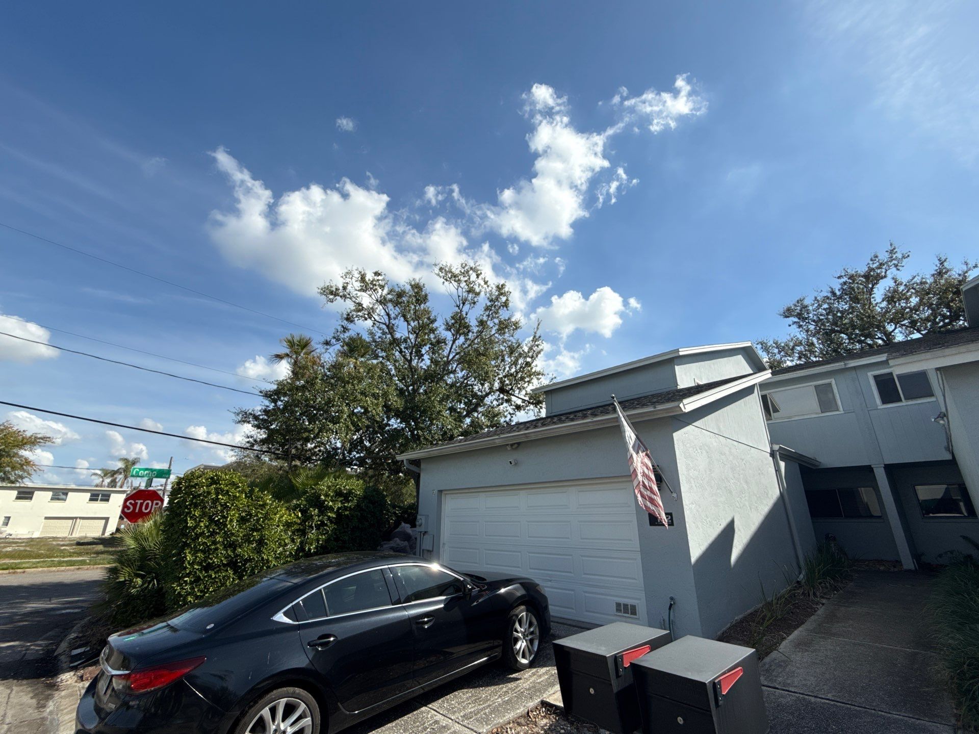 Professional air filtration equipment and plastic containment barriers set up with red tape to isolate the restoration work zone.