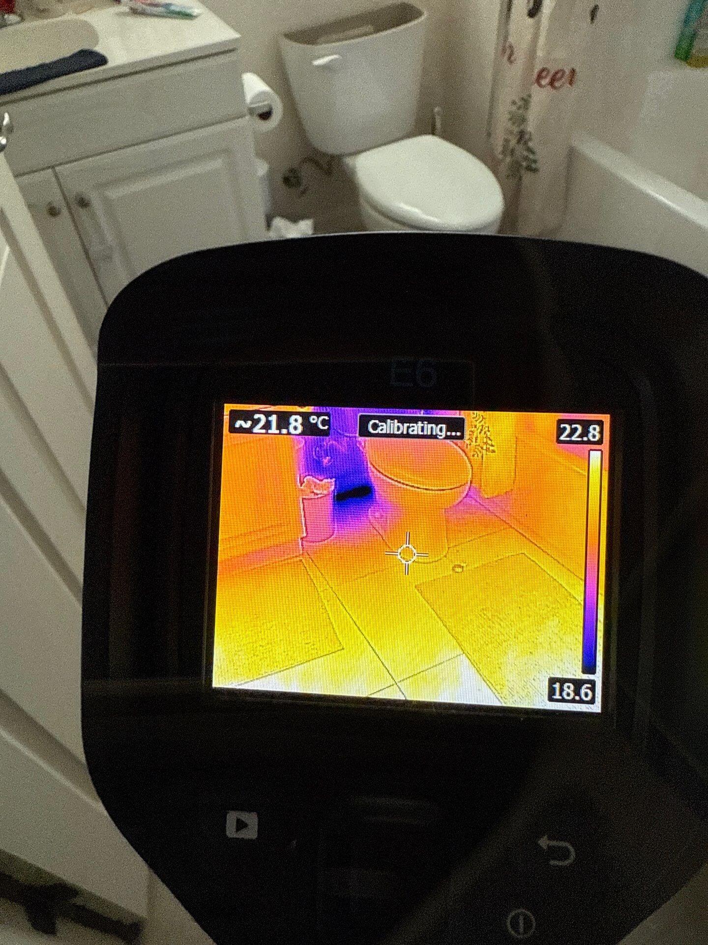 user-inserted Infrared thermal scan of a bathroom floor and toilet area to identify hidden water leaks or cool spots.