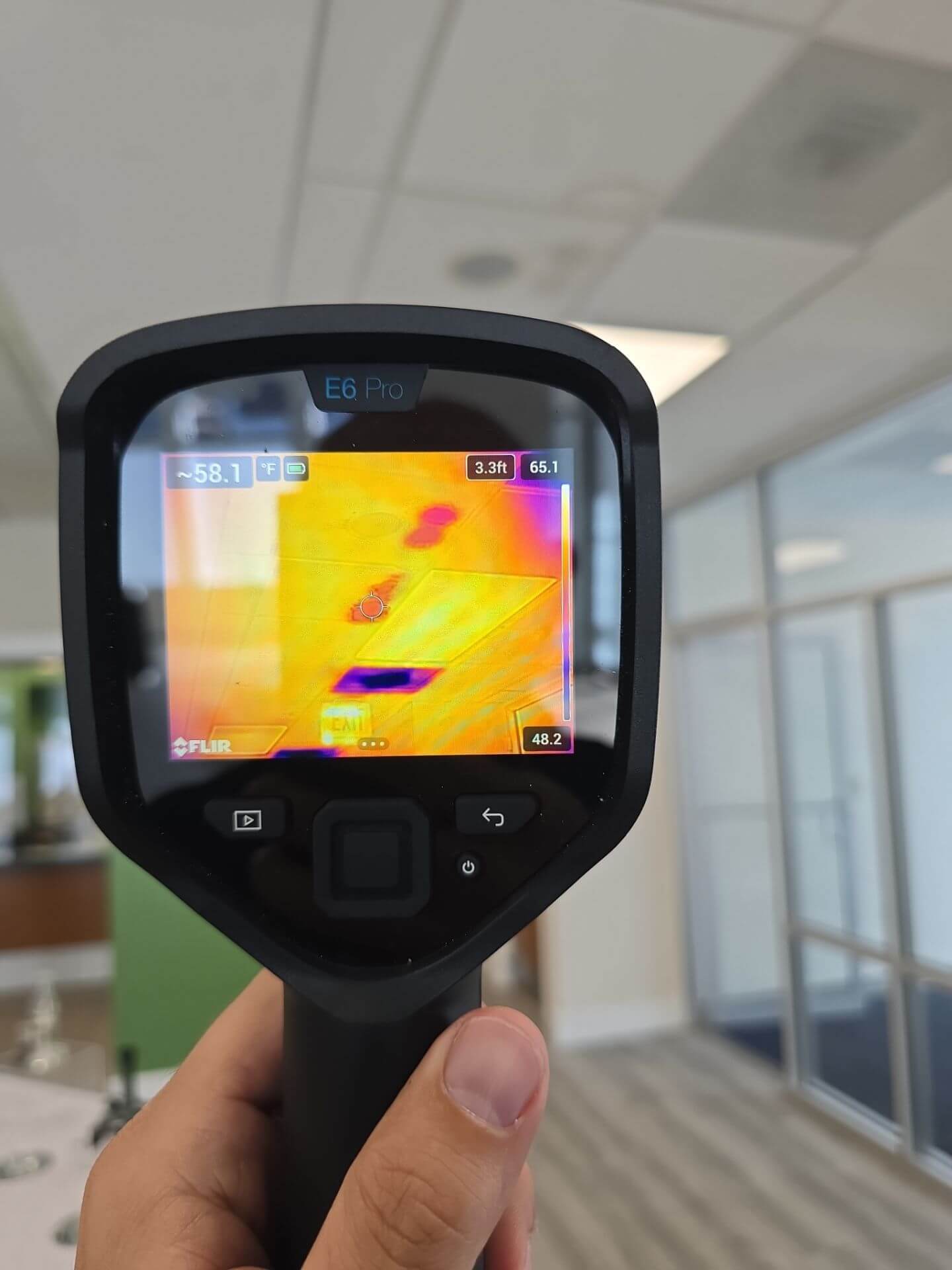 FLIR thermal imaging scan identifying an active water leak and moisture patterns hidden behind a commercial drop-tile ceiling.