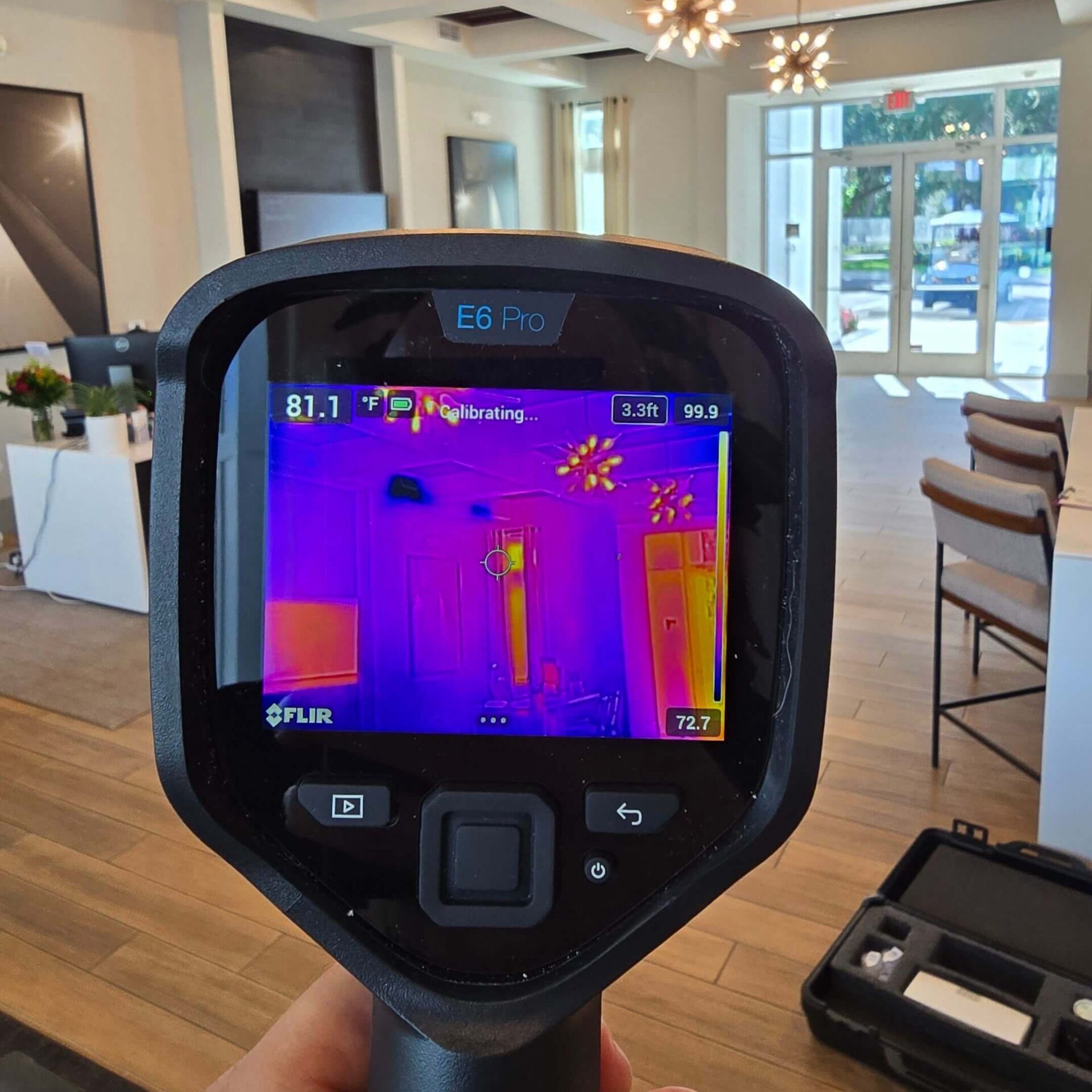 Using a FLIR E6 Pro thermal imaging camera to detect heat signatures and potential moisture intrusion in a commercial lobby.