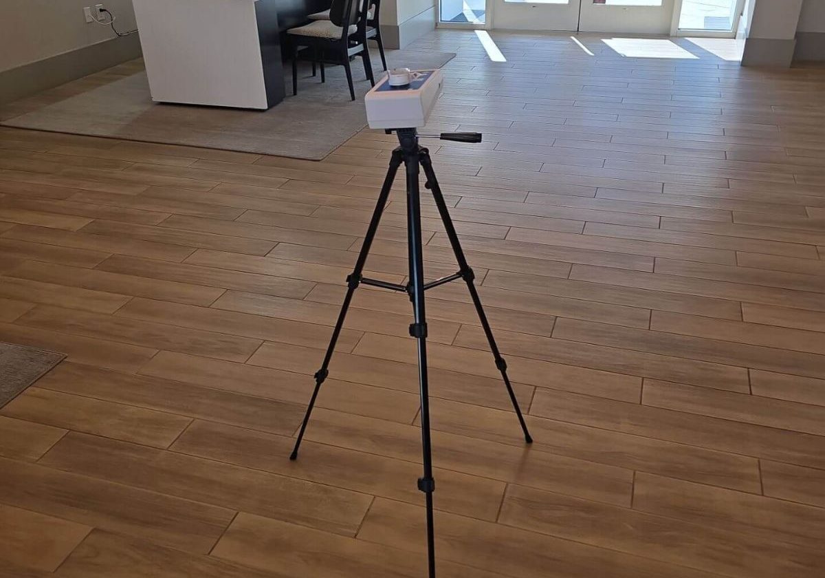 Air quality monitoring station positioned in a commercial reception area to measure VOCs and particulate matter.