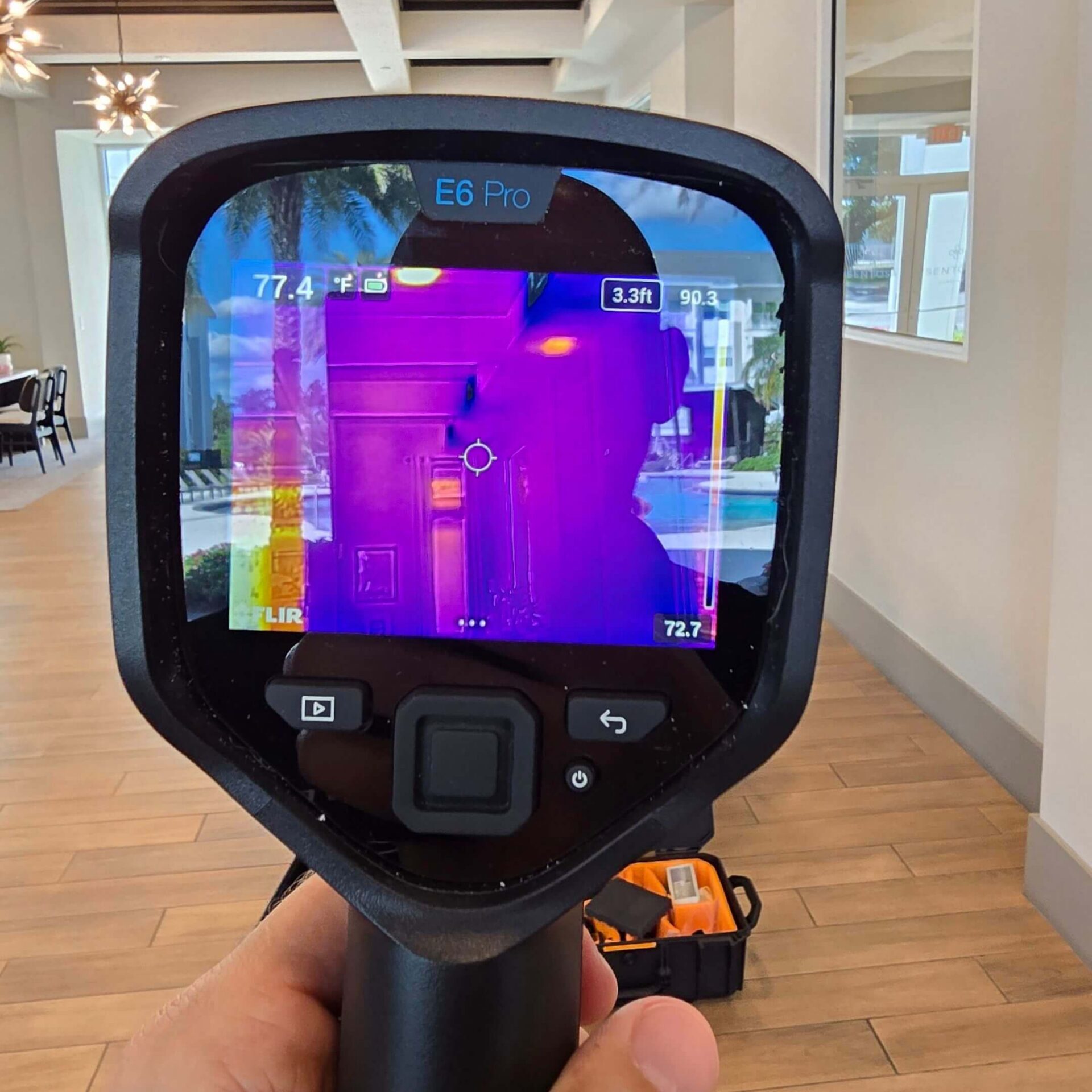 Close-up of an infrared thermography scan showing temperature variations on a building's interior wall to identify insulation gaps.