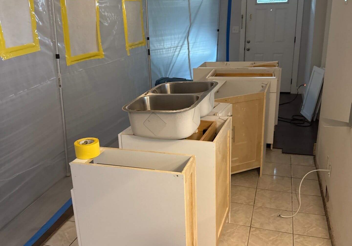 Kitchen area under negative air pressure with a containment barrier during a mold remediation project to ensure indoor air quality safety.