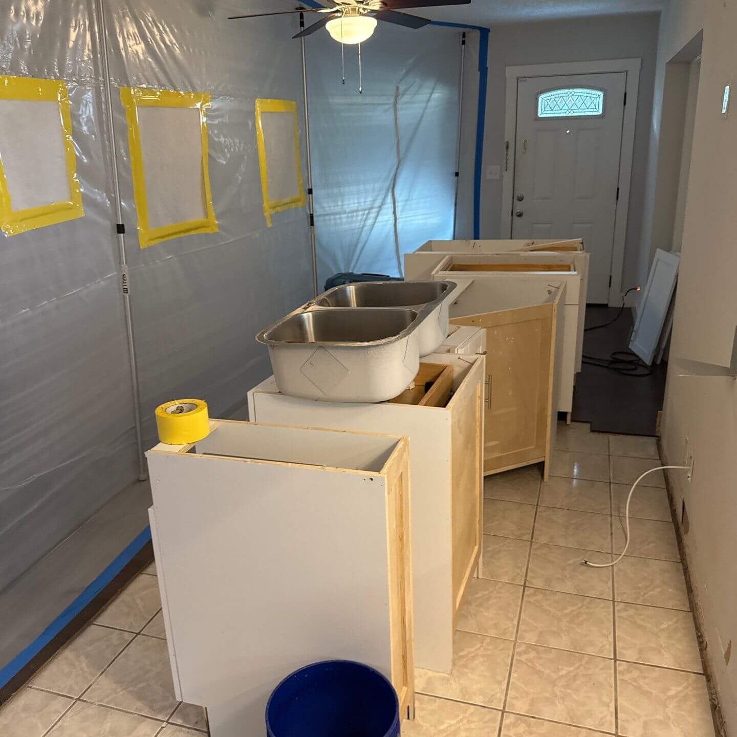 Kitchen area under negative air pressure with a containment barrier during a mold remediation project to ensure indoor air quality safety.